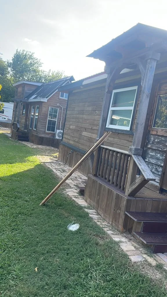 Dark-stained tiny home finished on a lot